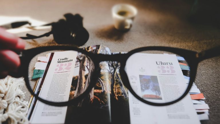 eyeglasses with brown frames and open book